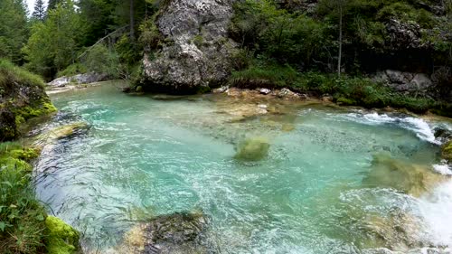4K a river flowing through rock boulders